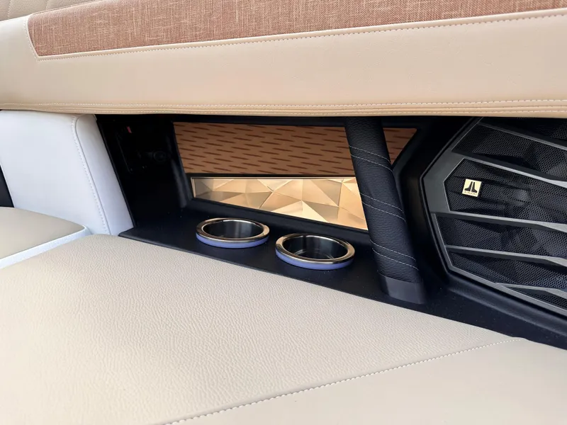 Slide: The Image of 2023 Nautique G21 boat interior with cup holders and speaker. - 10