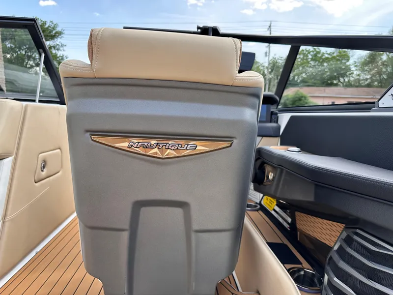 Slide: The Image of 2023 Nautique G21 boat interior with beige and gray seating. - 11