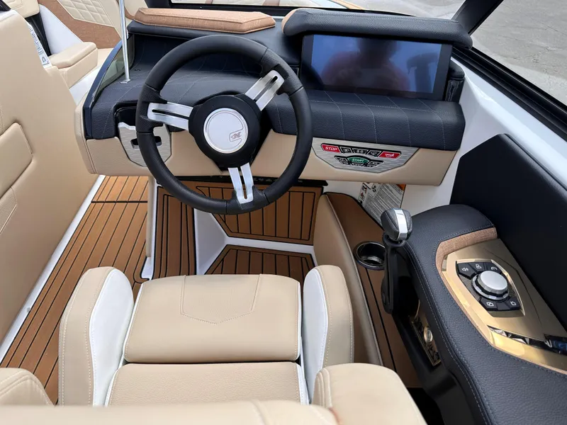 Slide: The Image of 2023 Nautique G21 boat interior with modern dashboard and steering wheel. - 12