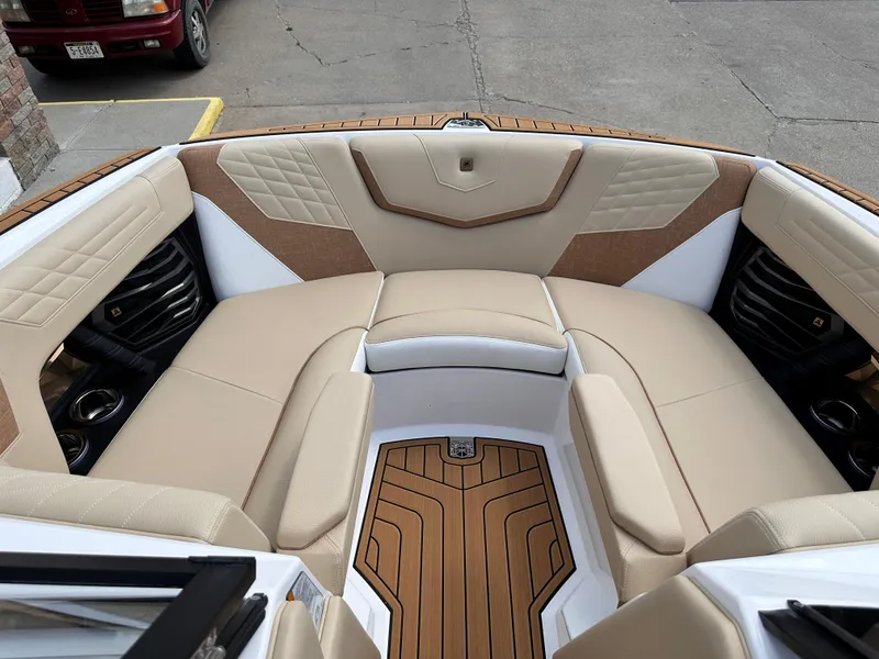Slide: The Image of 2023 Nautique G21 boat interior with beige and white cushioned seating. - 16