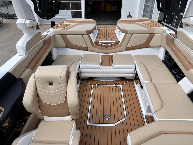 Slide: The Image of 2023 Nautique G21 boat interior with luxurious tan and white seating. - 17