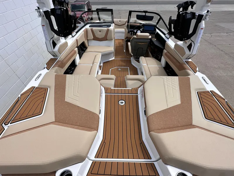 Slide: The Image of 2023 Nautique G21 boat interior with tan and brown seating and teak flooring. - 19