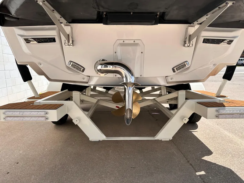 Slide: The Image of 2023 Nautique G21 boat stern view with propeller and trailer. - 4