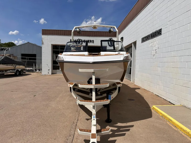 Slide: The Image of 2023 Nautique G21 boat on trailer outside dealership. - 6