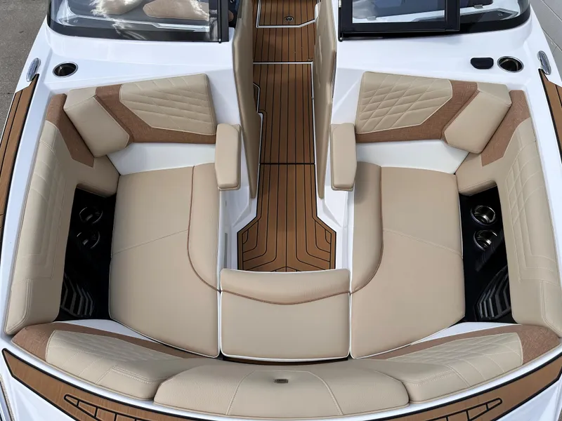Slide: The Image of 2023 Nautique G21 boat interior with beige and brown seating. - 7