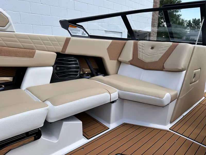 Slide: The Image of 2023 Nautique G21 boat interior with tan and white seating. - 9