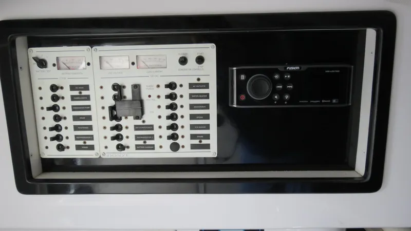 Slide: The Image of Control panel of a 2006 Donzi 43 ZR boat with switches and gauges. - 34