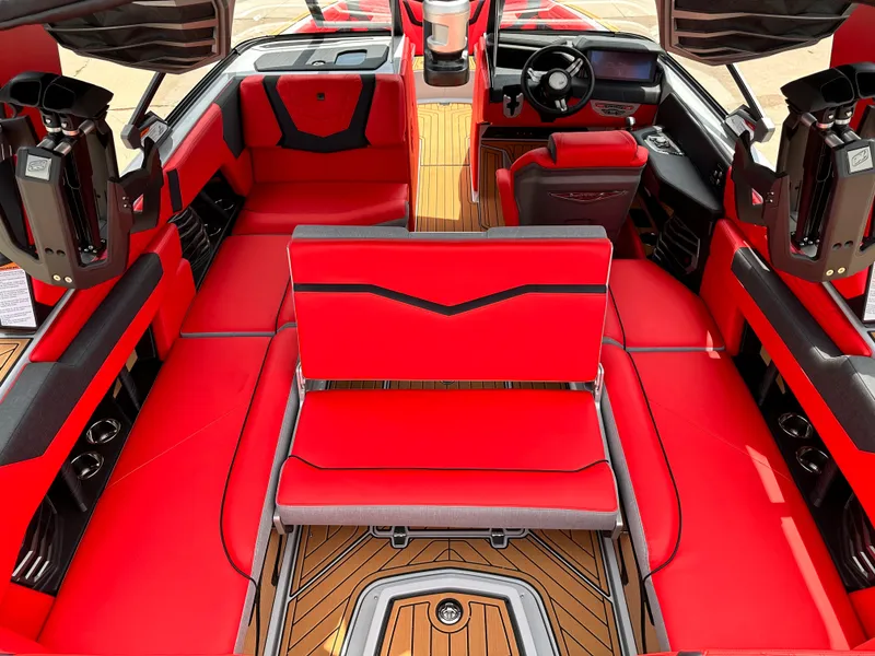 Slide: The Image of 2023 Nautique G23 boat interior with red and black seating, wood flooring. - 15