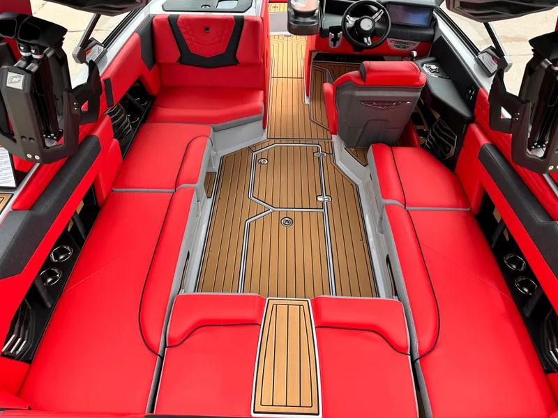 Slide: The Image of 2023 Nautique G23 boat interior with red seating and teak flooring. - 16