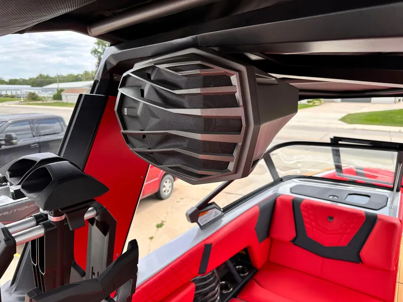 Slide: The Image of 2023 Nautique G23 boat interior with red seating and speaker system. - 17