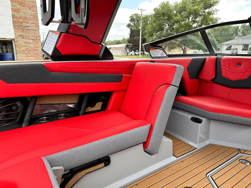 Slide: The Image of 2023 Nautique G23 boat interior with red and gray seating, modern design. - 24