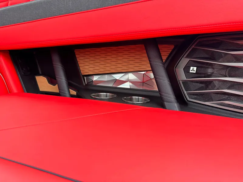 Slide: The Image of 2023 Nautique G23 interior detail with red upholstery and JL Audio speaker. - 25