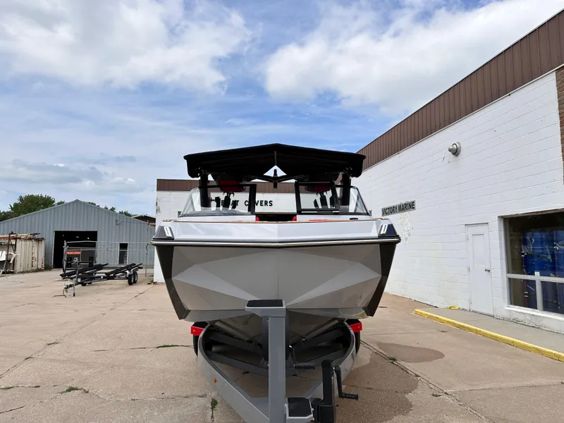 Slide: The Image of 2023 Nautique G23 boat on trailer outside a warehouse. - 5