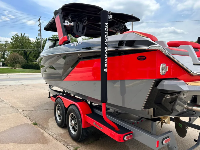 Slide: The Image of 2023 Nautique G23 boat on a red trailer, side view. - 7