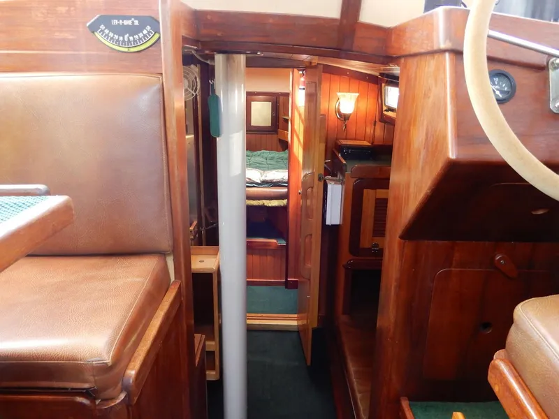 Slide: The Image of 1977 Ted Brewer Jason Pilothouse Offshore yacht interior with wooden furnishings and cozy cabin. - 1
