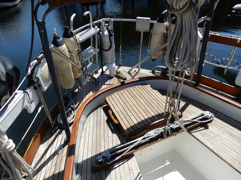 Slide: The Image of 1977 Ted Brewer Jason Pilothouse Offshore yacht deck with ropes and wooden flooring. - 11