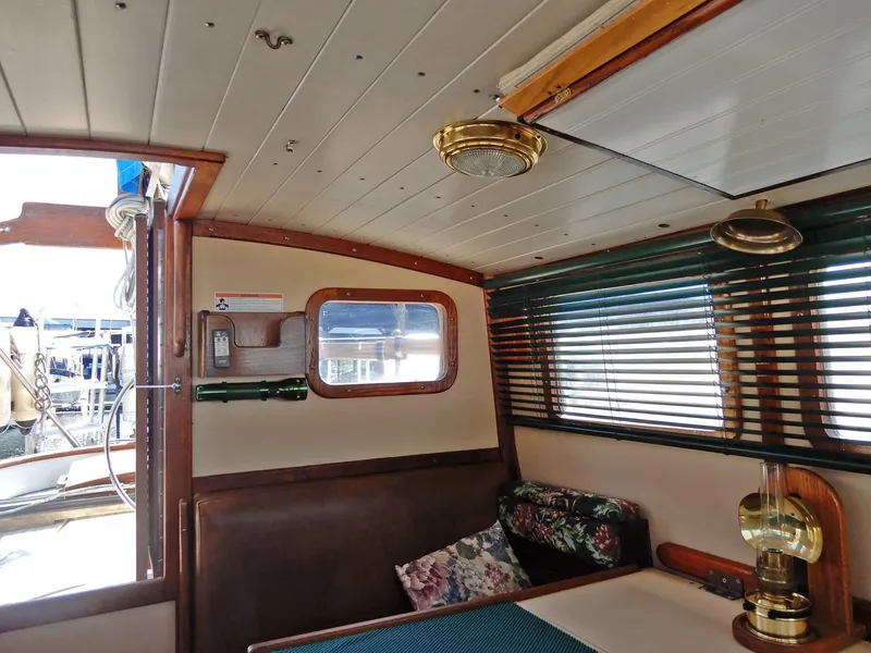 Slide: The Image of Interior of 1977 Ted Brewer Jason Pilothouse Offshore yacht with wood paneling and nautical decor. - 4
