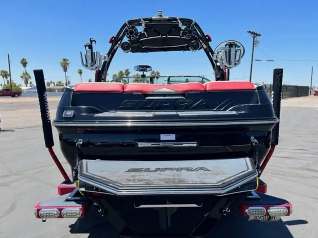 Slide: The Image of 2014 Supra SC350-550 boat rear view with wakeboard tower and swim platform. - 7