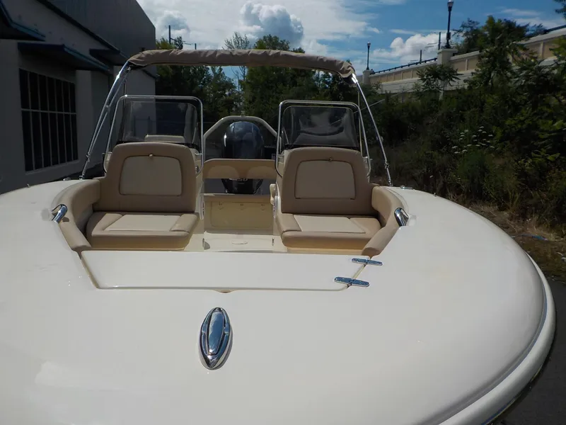 Slide: The Image of 2024 Scout 195 Sport Dorado boat with beige seating and dual consoles. - 4