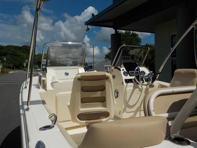 Slide: The Image of 2024 Scout 195 Sport Dorado boat interior with steering console and seating. - 5
