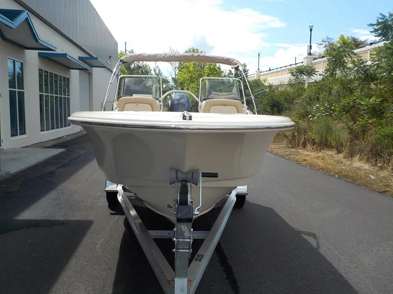 Slide: The Image of 2024 Scout 195 Sport Dorado boat on trailer, parked outdoors near a building. - 6