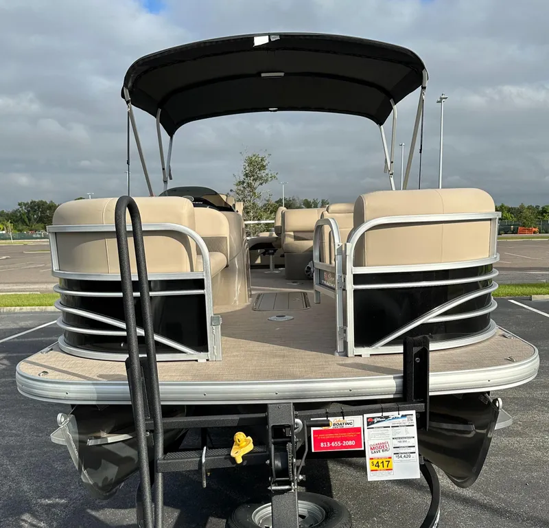 Slide: The Image of 2023 Sun Tracker SportFish 22 XP3 pontoon boat with beige seating and black canopy. - 10