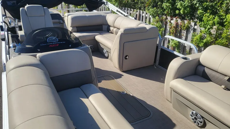 Slide: The Image of 2023 Sun Tracker SportFish 22 XP3 pontoon boat with spacious seating and modern design. - 3