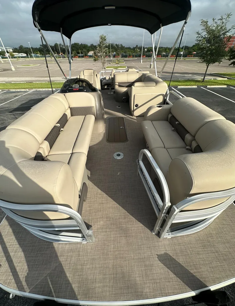 Slide: The Image of 2023 Sun Tracker SportFish 22 XP3 pontoon boat with beige seating and canopy. - 9