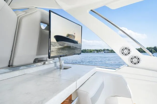 Slide: The Image of Tiara Yachts 38LS 2024 model interior with TV and scenic water view. - 10