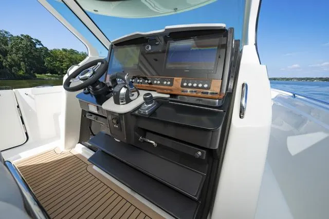 Slide: The Image of 2024 Tiara Yachts 38LS helm station with advanced navigation systems. - 11