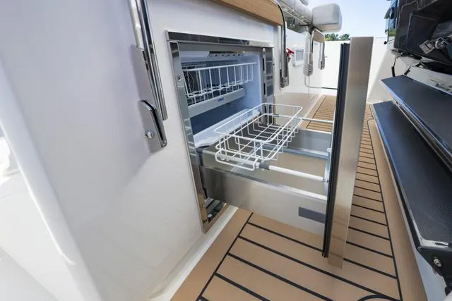 Slide: The Image of 2024 Tiara Yachts 38LS, open drawer refrigerator on deck. - 15