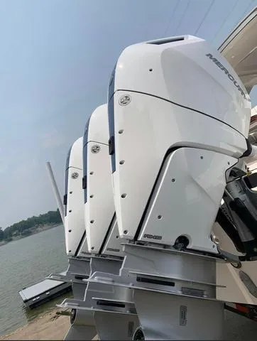 Slide: The Image of 2024 Tiara Yachts 38LS with triple Mercury outboard engines by the water. - 4