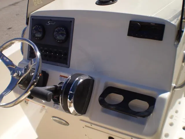 Slide: The Image of 2023 Scout 195 Sportfish boat dashboard with steering wheel and controls. - 4