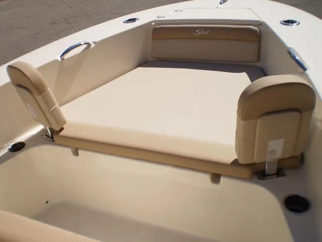Slide: The Image of 2023 Scout 195 Sportfish boat interior with beige seating and stainless steel handles. - 5