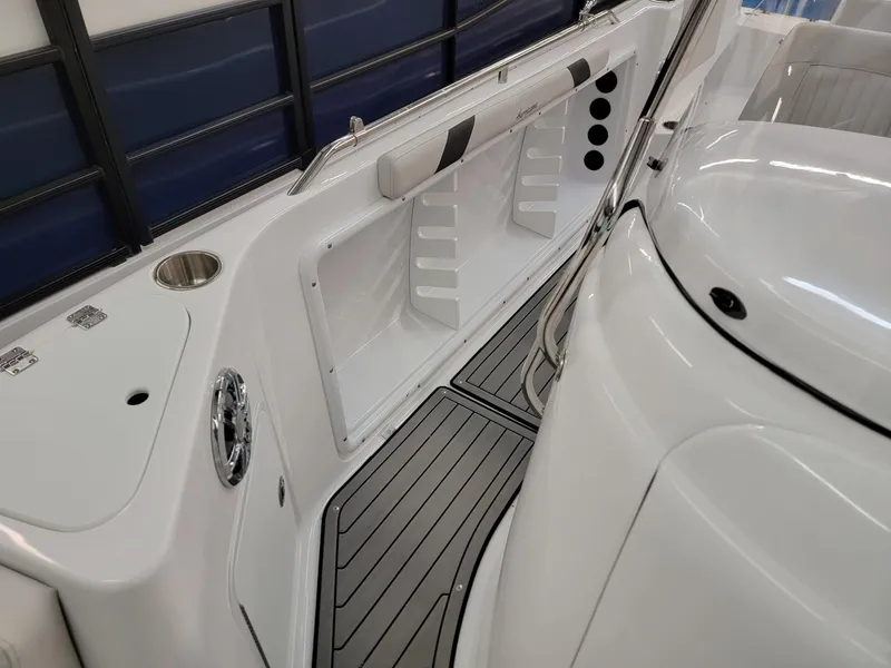 Slide: The Image of 2024 Hurricane SunDeck Sport CC 231 OB boat interior with white seating and storage compartments. - 11