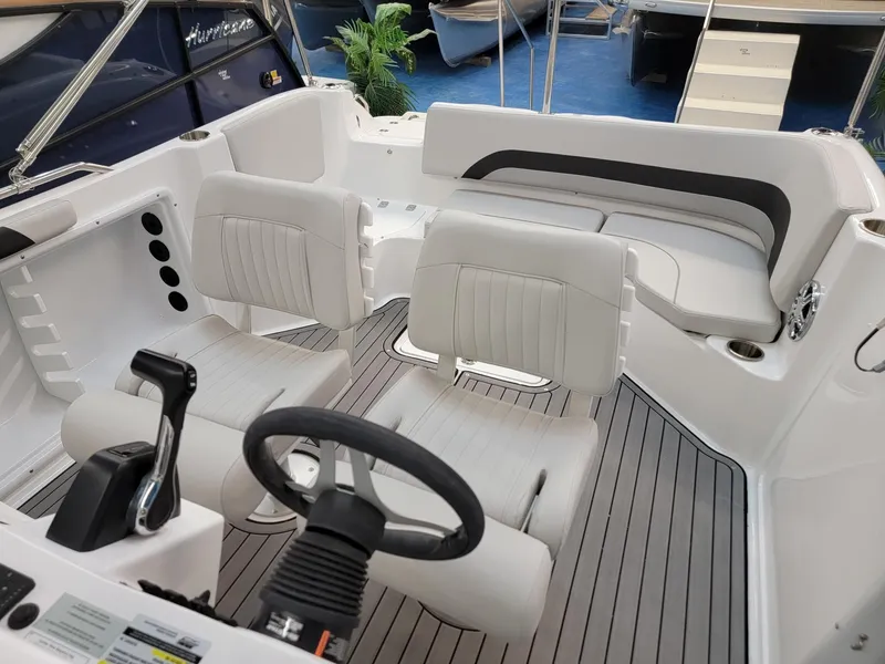 Slide: The Image of 2024 Hurricane SunDeck Sport CC 231 OB boat interior, featuring storage compartments and sleek design. - 12