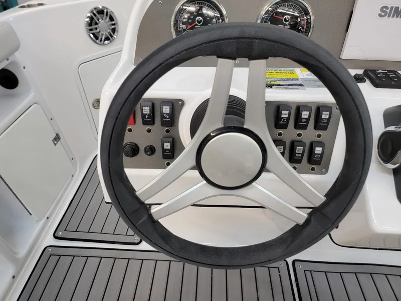 Slide: The Image of 2024 Hurricane SunDeck Sport CC 231 OB boat dashboard with Simrad electronics and gauges. - 16