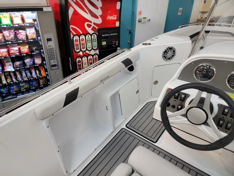 Slide: The Image of 2024 Hurricane SunDeck Sport CC 231 OB dashboard with gauges and capacity label. - 18