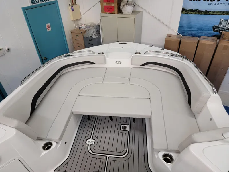 Slide: The Image of 2024 Hurricane SunDeck Sport CC 231 OB boat interior with dashboard and seating. - 26