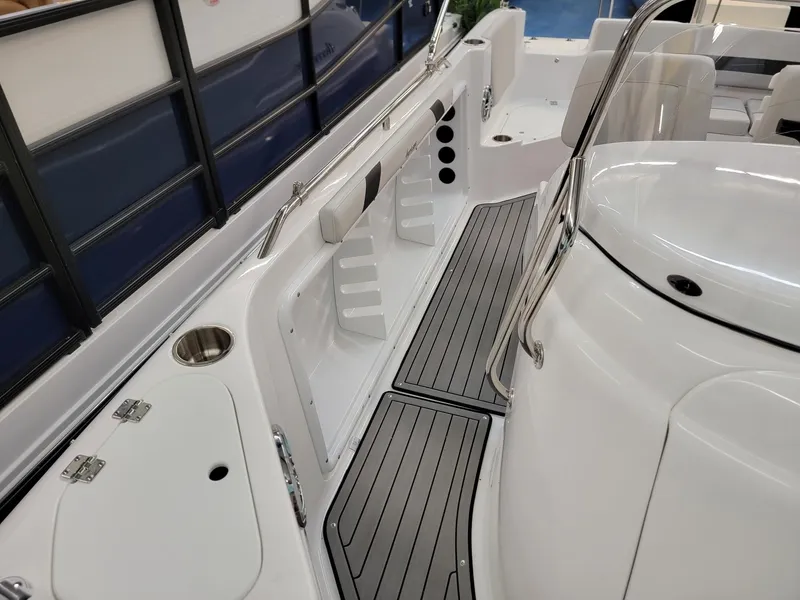 Slide: The Image of 2024 Hurricane SunDeck Sport CC 231 OB boat interior, white seating, and steering console. - 8