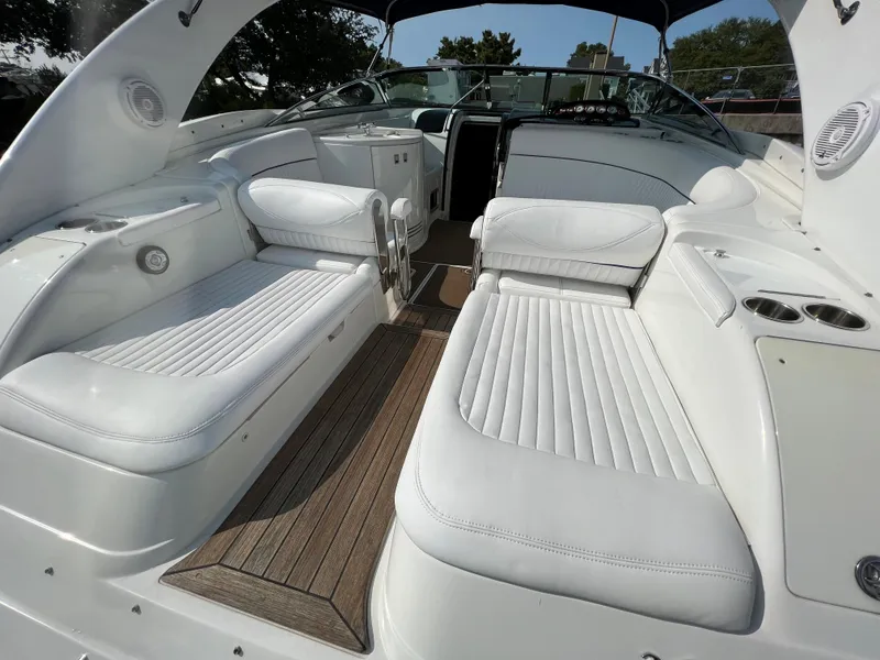 Slide: The Image of 2004 Cobalt 360 boat interior with white leather seating and wood flooring. - 10