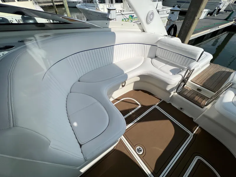 Slide: The Image of 2004 Cobalt 360 boat interior with white leather seating and brown flooring. - 11