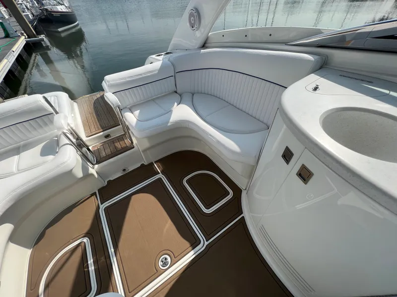 Slide: The Image of Interior of a 2004 Cobalt 360 boat with white seating and brown flooring. - 13
