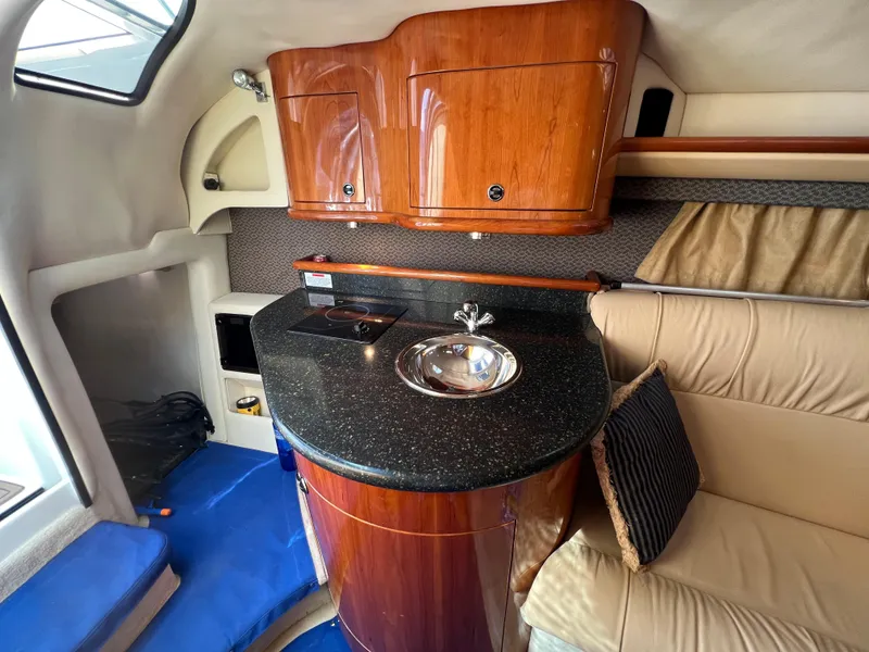 Slide: The Image of 2004 Cobalt 360 boat interior with kitchenette and seating area - 22