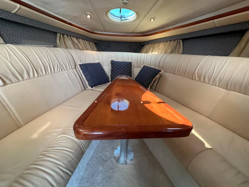 Slide: The Image of Luxurious interior of a 2004 Cobalt 360 boat with plush seating and wooden table. - 24