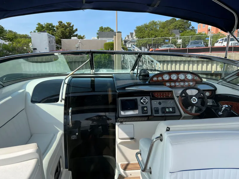 Slide: The Image of 2004 Cobalt 360 boat cockpit with steering wheel and instrument panel. - 32