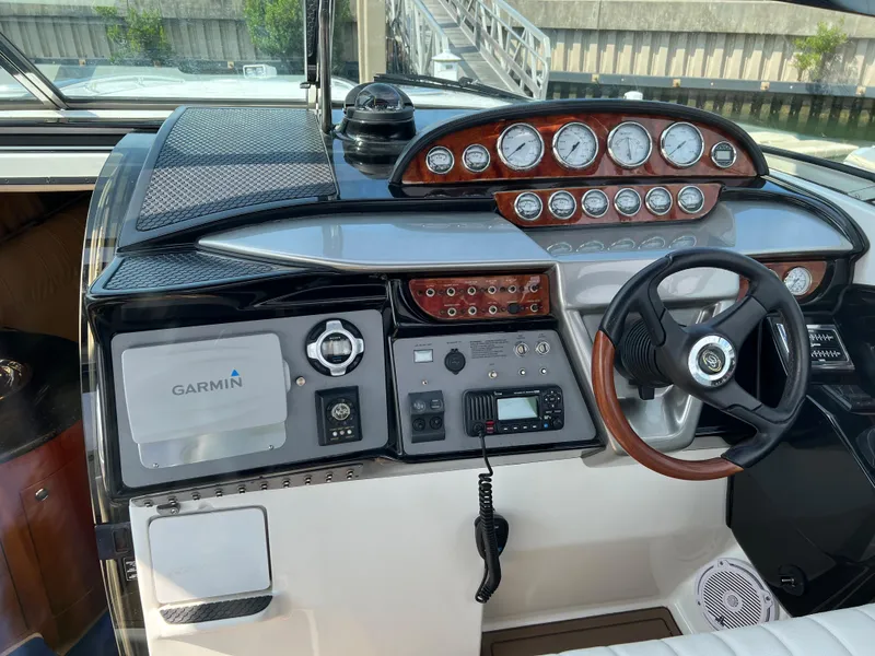 Slide: The Image of 2004 Cobalt 360 boat dashboard with Garmin navigation system and steering wheel. - 39