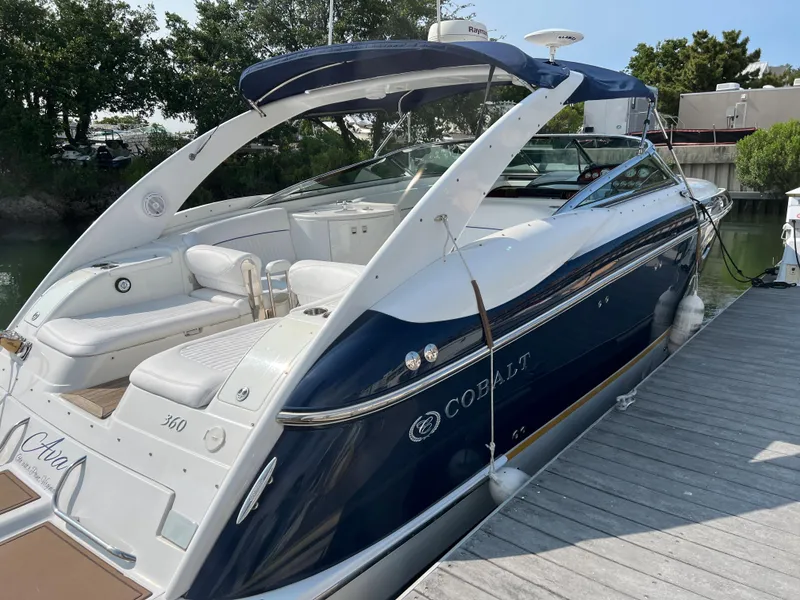 Slide: The Image of 2004 Cobalt 360 luxury motorboat docked at marina. - 6