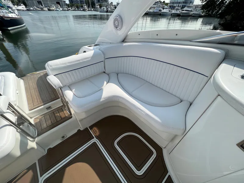 Slide: The Image of Luxurious white seating area on a 2004 Cobalt 360 boat docked at a marina. - 8