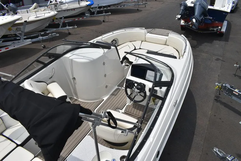Slide: The Image of 2023 Stingray 231DC boat interior with seating and steering console. - 10